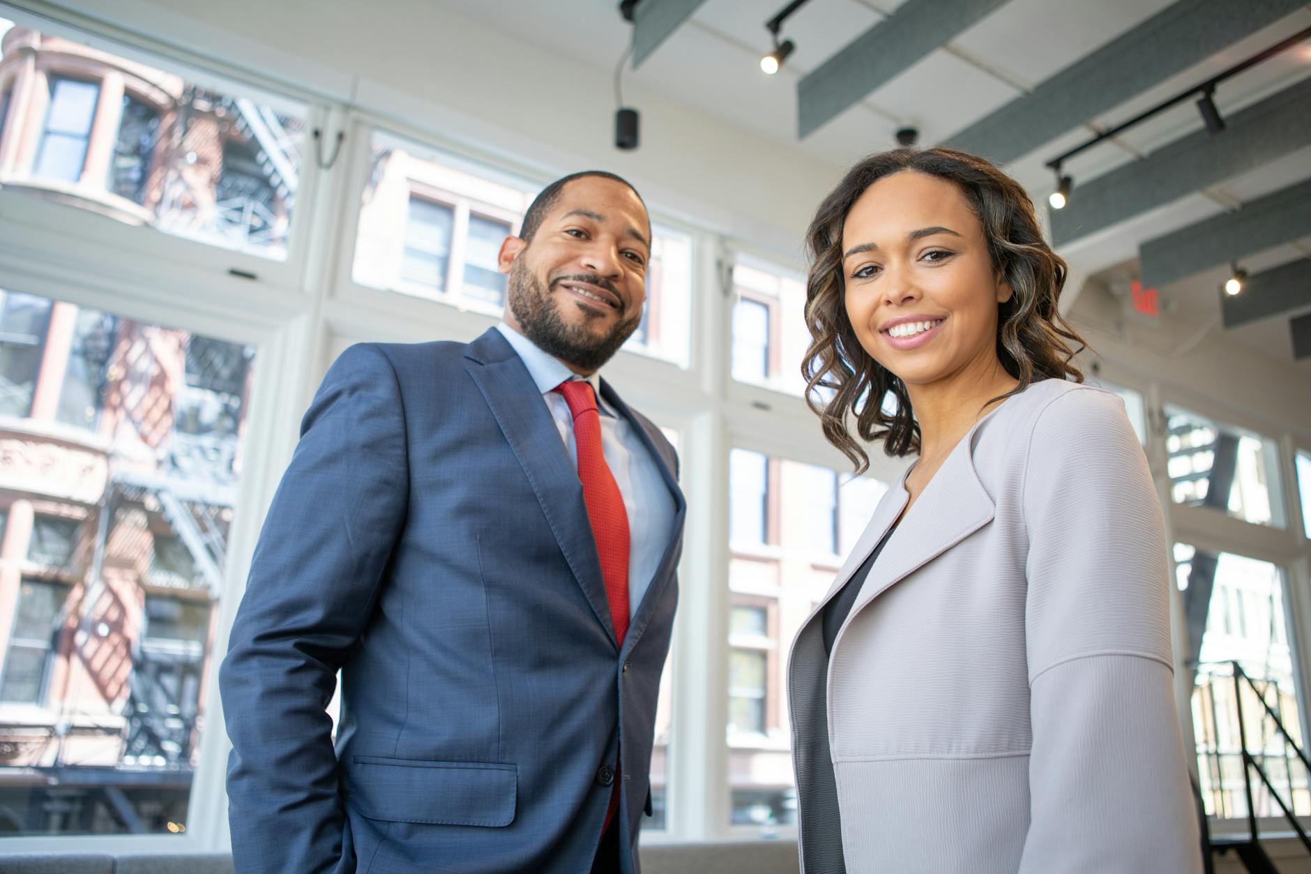 man and woman smiling inside building